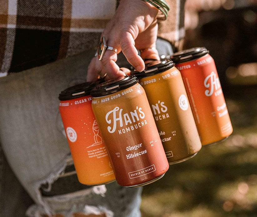 Han's Kombucha six pack of hands being held